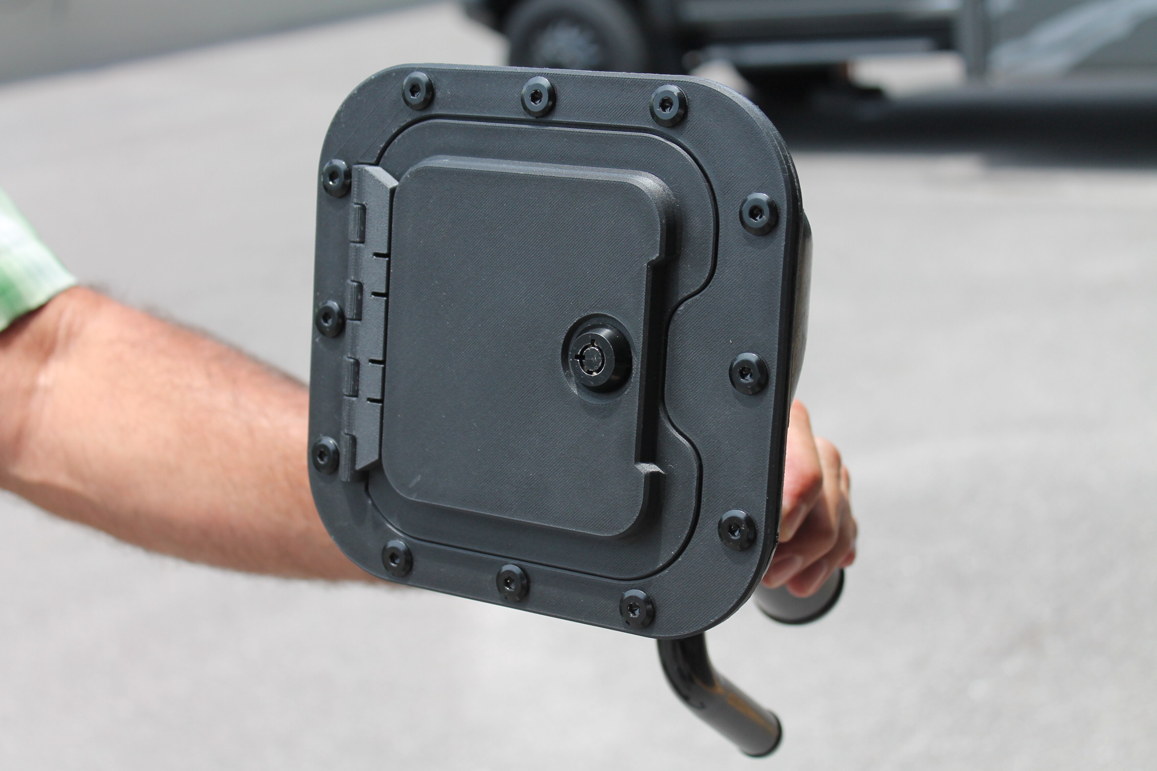 Gas Protector locking fuel door close-up — precision-engineered hinge and industrial-grade locking mechanism prevents forced entry and fuel siphoning